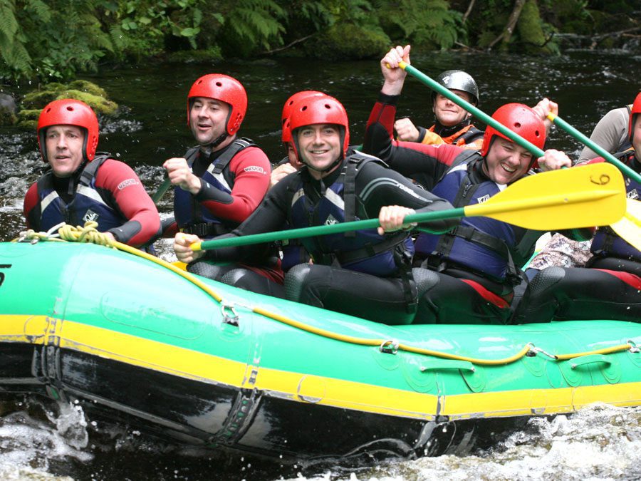 White Water rafting stag group on River Rhondda, Wales