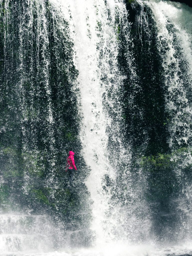 Walking under the Sgwd Isaf Clun Gwyn waterfall