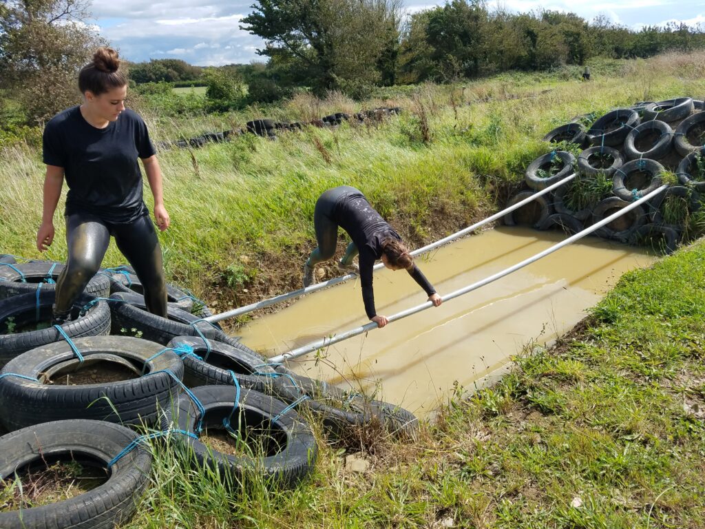 Muddy pole traverse Pole traverse at Adventures Wales Muddy Assault Course