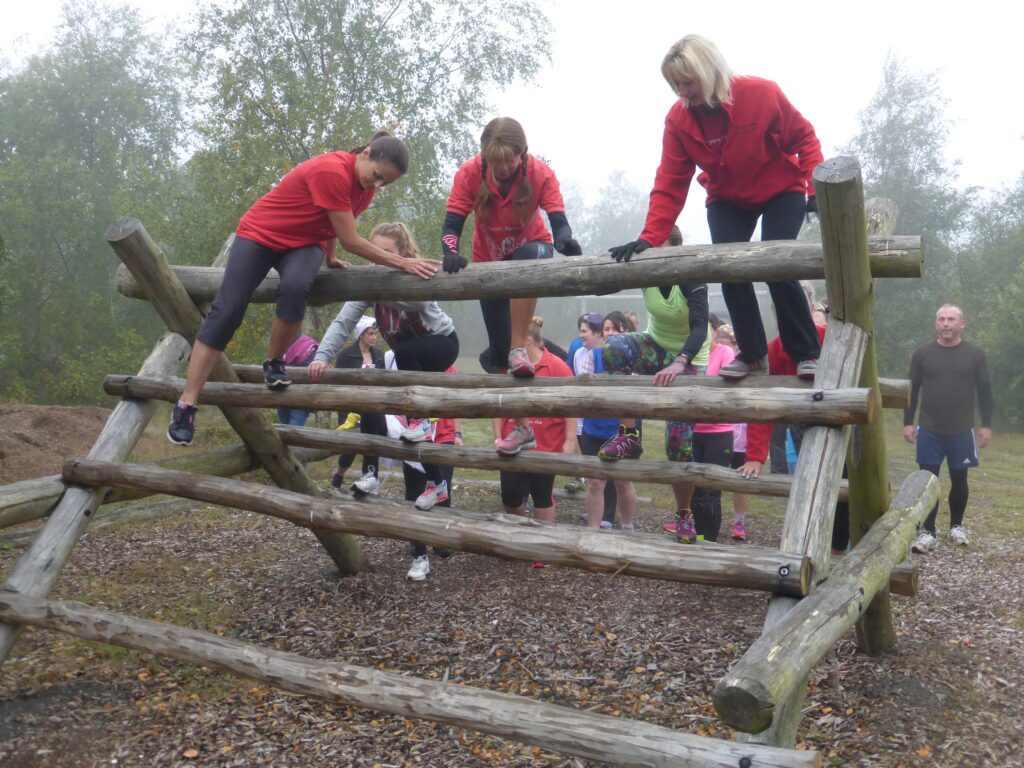 Groups climbing through the obstacle course